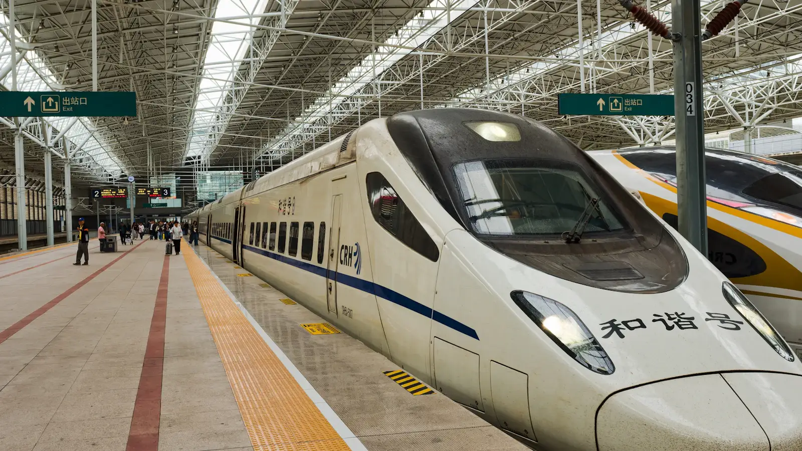 China train ticket booking app on smartphone with railway station background