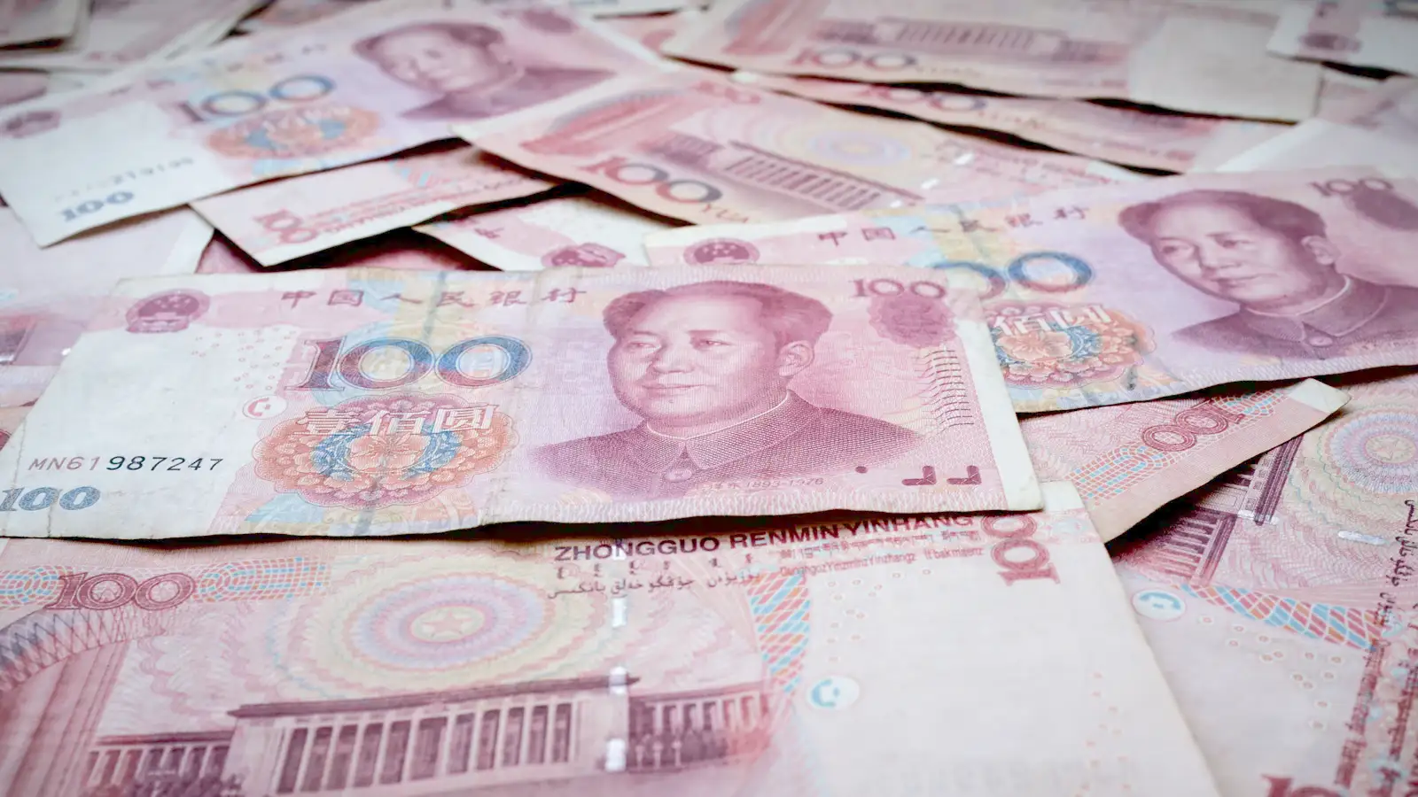 Chinese yuan banknotes and coins spread on a surface